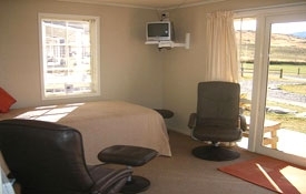 The lounge has one king-size single bed - Large Sized Cottage